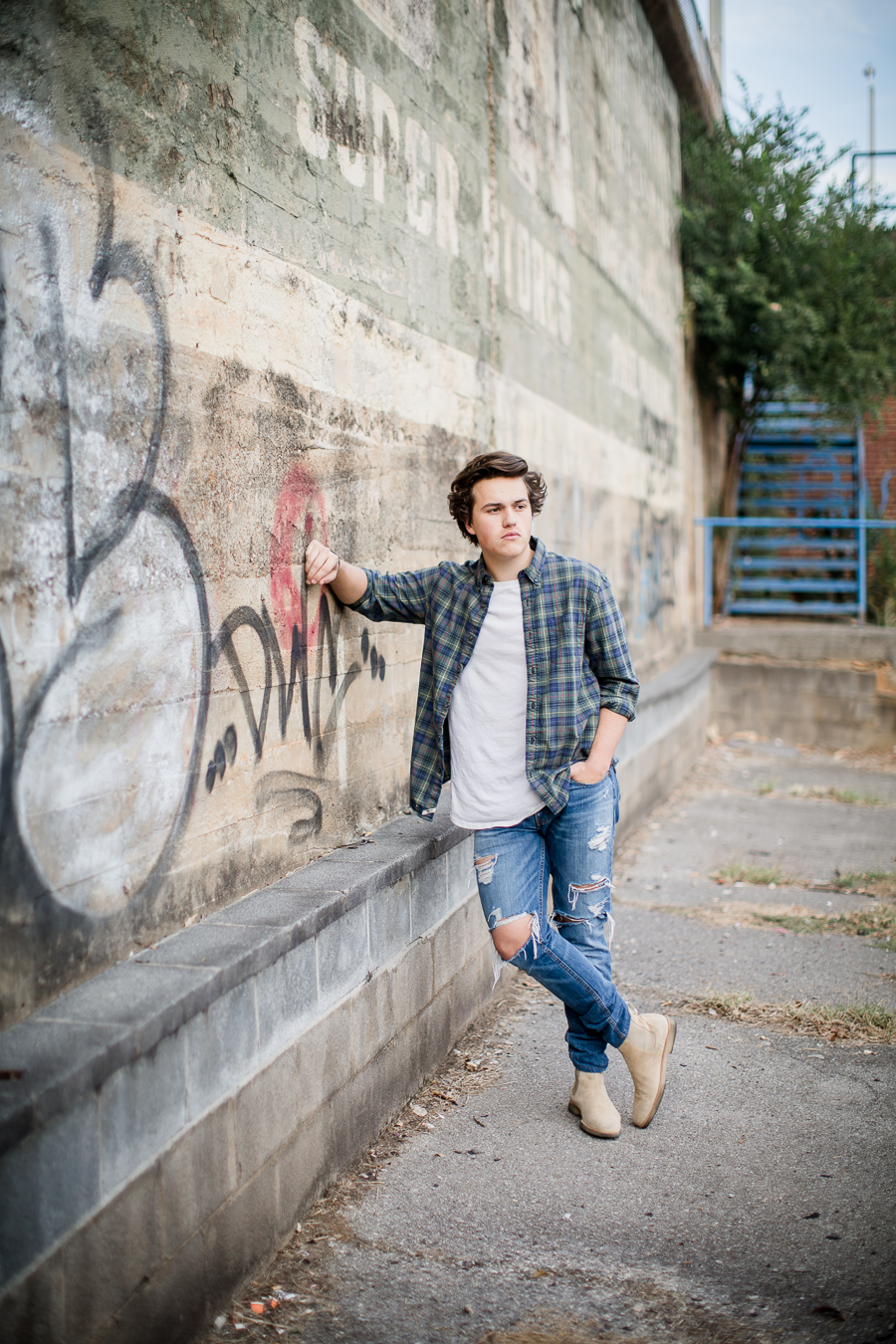 Posted up on painted wall at this Maryville, TN Senior session by Knoxville Wedding Photographer, Amanda May Photos.
