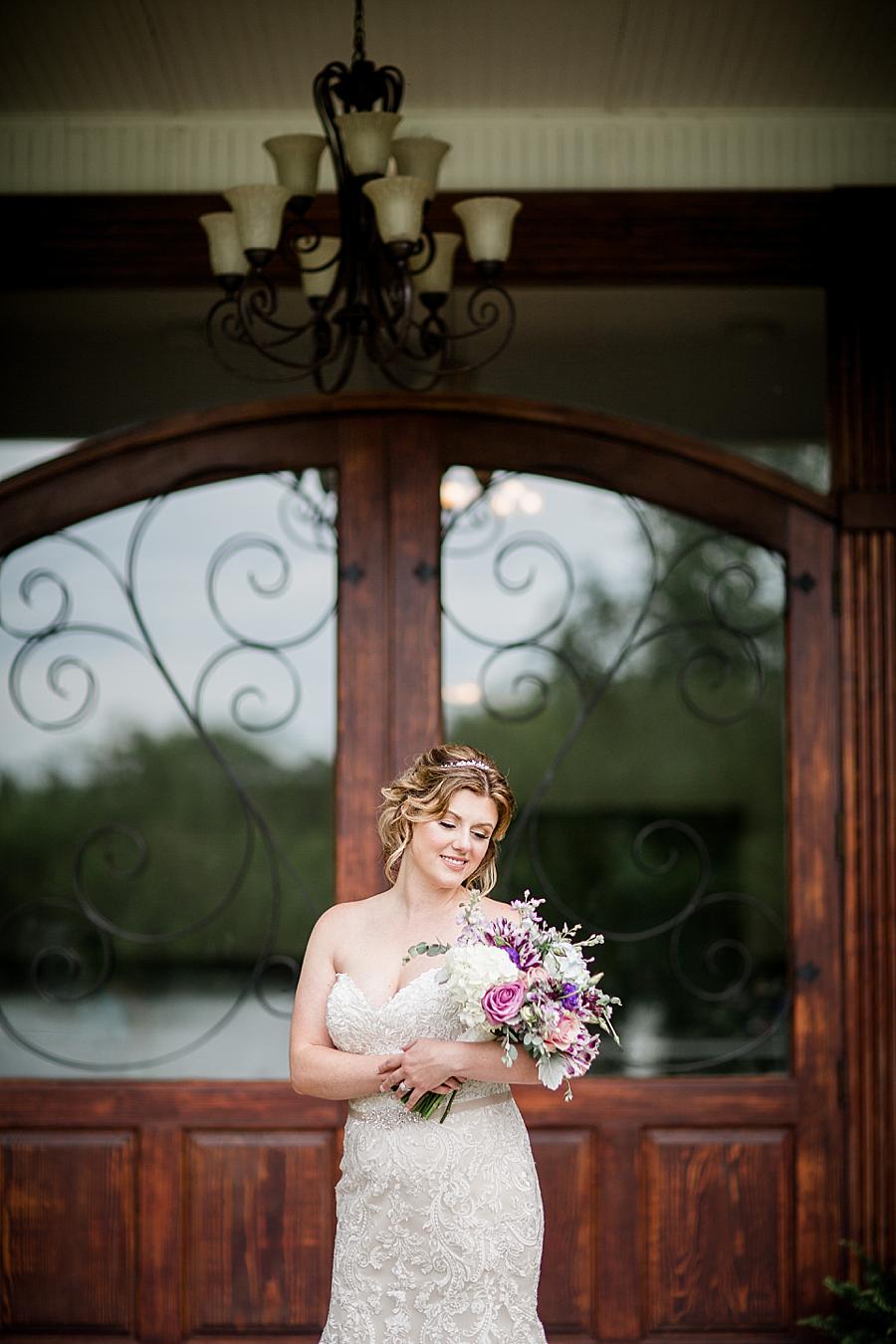 Cradling the bouquet at this Hunter Valley Pavilion Wedding by Knoxville Wedding Photographer, Amanda May Photos.