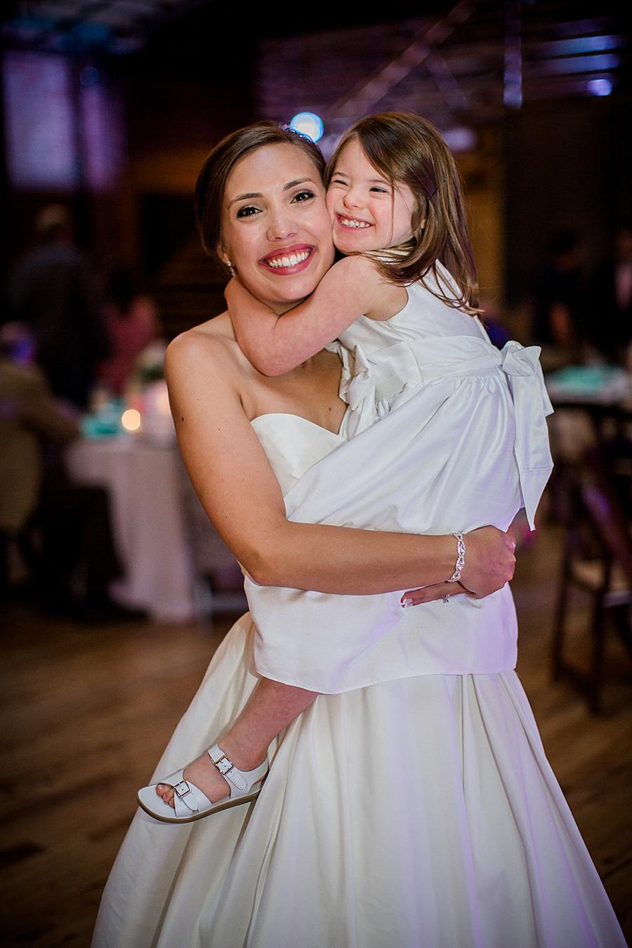 Holding the flower girl at this Fountain City Church Wedding by Knoxville Wedding Photographer, Amanda May Photos.