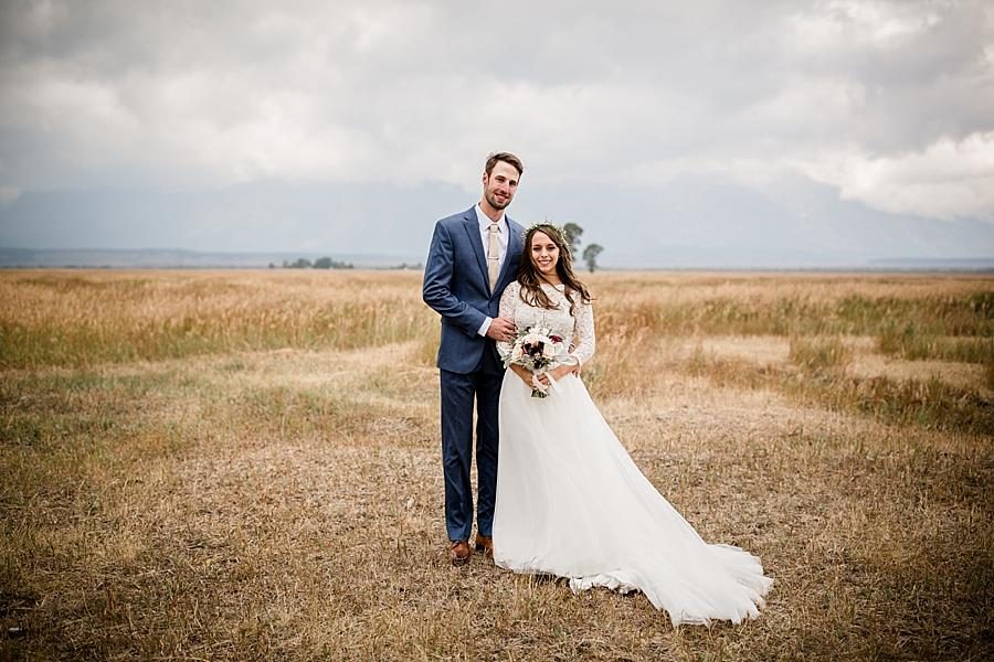 Standing in field at this Grand Tetons Destination Wedding by Knoxville Wedding Photographer, Amanda May Photos.