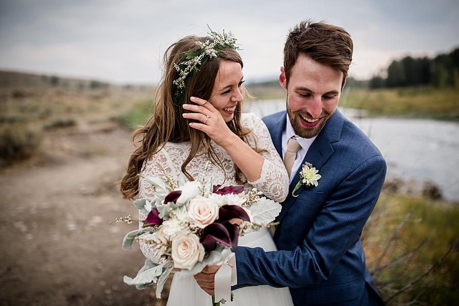 Laughing with each other by lake at this Grand Tetons Destination Wedding by Knoxville Wedding Photographer, Amanda May Photos.
