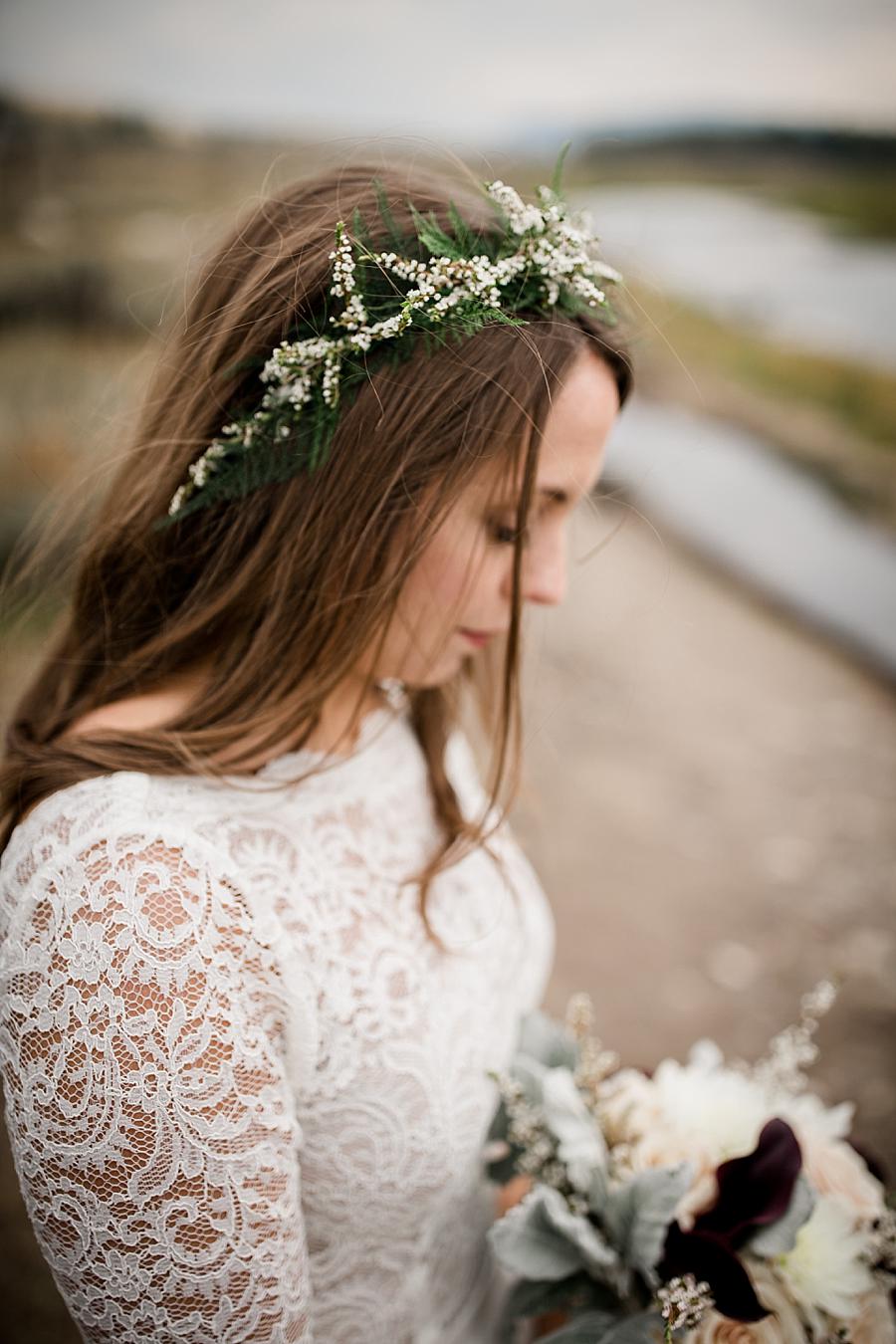 Bride looking down at flowers at this Grand Tetons Destination Wedding by Knoxville Wedding Photographer, Amanda May Photos.