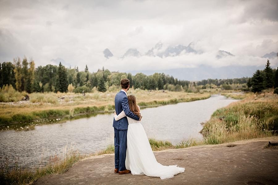 Hugging looking at lake at this Grand Tetons Destination Wedding by Knoxville Wedding Photographer, Amanda May Photos.