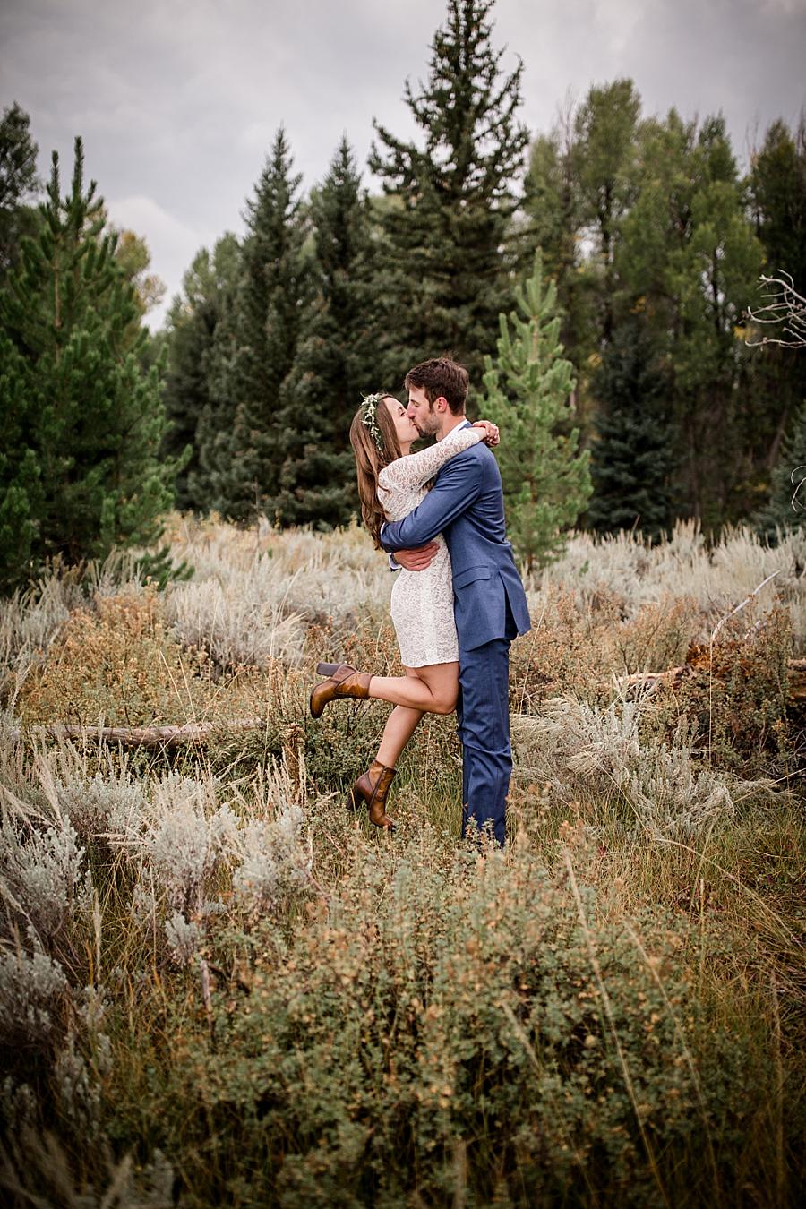 Picking her up and kissing her at this Grand Tetons Destination Wedding by Knoxville Wedding Photographer, Amanda May Photos.