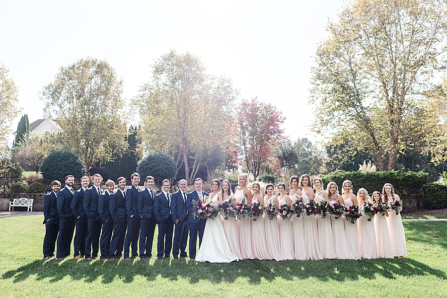 Couple and wedding party at this fall castleton farms wedding