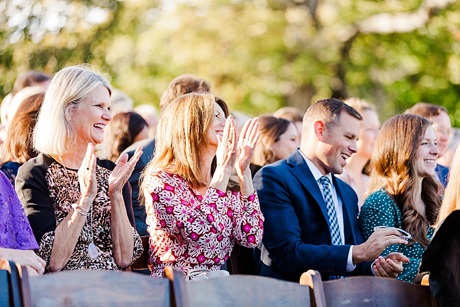 Guests clapping at this fall castleton farms wedding