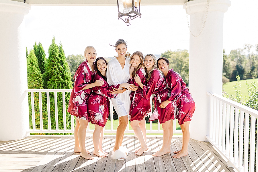 cranberry robes at this fall wedding at castleton farms
