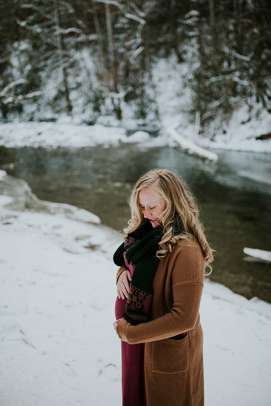  Knoxville, TN Smoky Mountain maternity photos, looking down with water behind her.