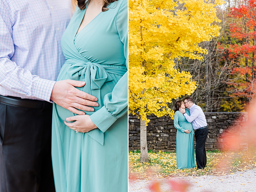 husband kissing pregnant wife under yellow tree