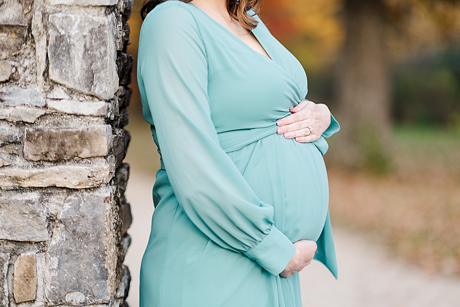 pregnant woman cradling her baby bump