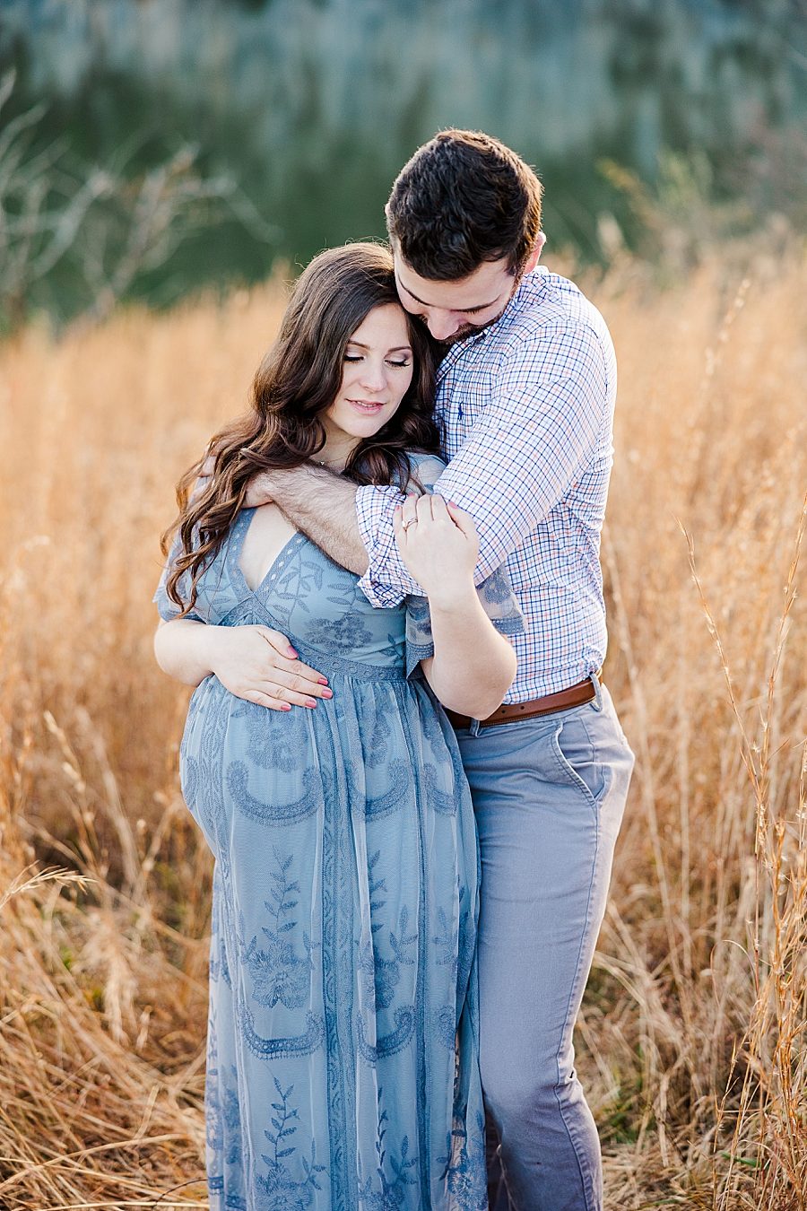couple snuggling at golden melton hill maternity