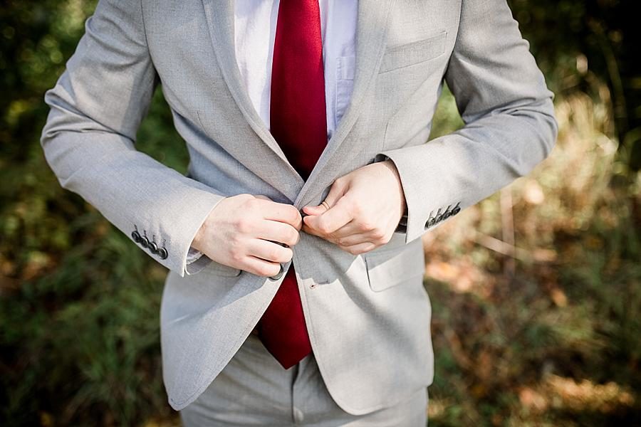 Buttoning jacket at this Toqua Campground Wedding by Knoxville Wedding Photographer, Amanda May Photos.