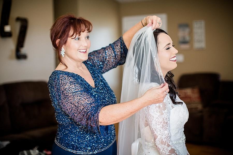 Putting on the veil at this Toqua Campground Wedding by Knoxville Wedding Photographer, Amanda May Photos.
