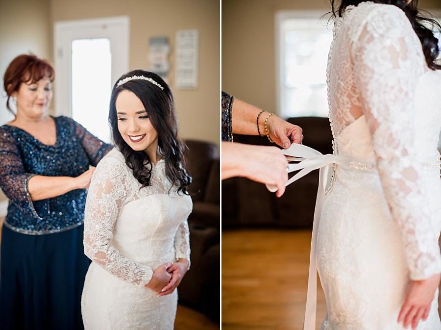 Tying the dress at this Toqua Campground Wedding by Knoxville Wedding Photographer, Amanda May Photos.