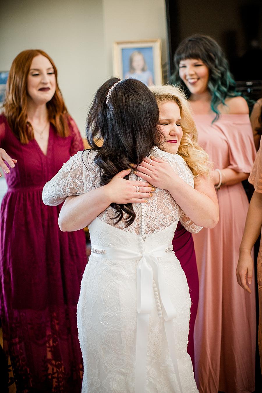 Hugging a bridesmaid at this Toqua Campground Wedding by Knoxville Wedding Photographer, Amanda May Photos.