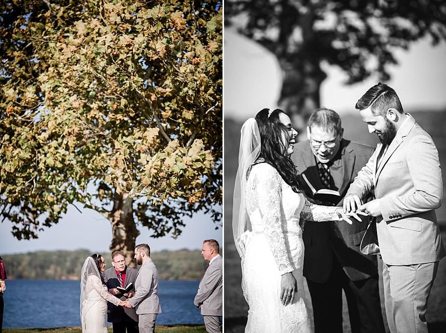 Exchanging rings at this Toqua Campground Wedding by Knoxville Wedding Photographer, Amanda May Photos.