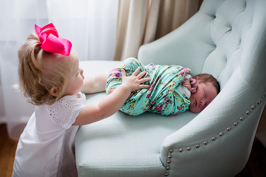 Big sis grabbing baby sis at this newborn session by Knoxville Wedding Photographer, Amanda May Photos.