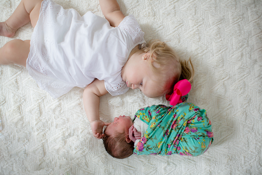 Laying back to back on the floor at this newborn session by Knoxville Wedding Photographer, Amanda May Photos.