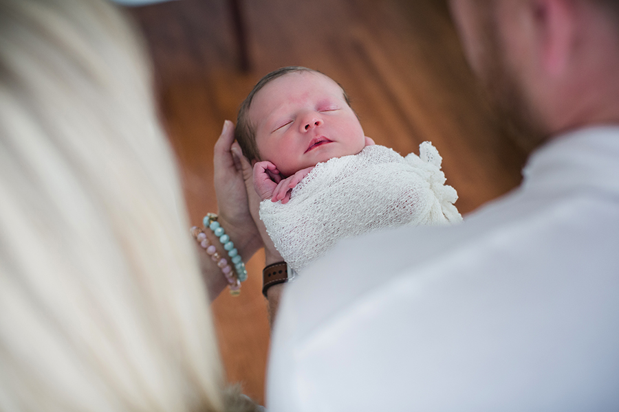 Holding newborn out and looking at her at this newborn session by Knoxville Wedding Photographer, Amanda May Photos.