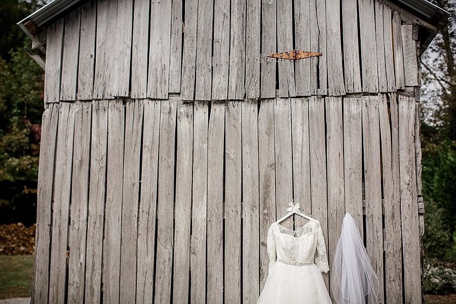 Dress hanging on old barn at this Sampson's Hollow Fall Wedding by Knoxville Wedding Photographer, Amanda May Photos.