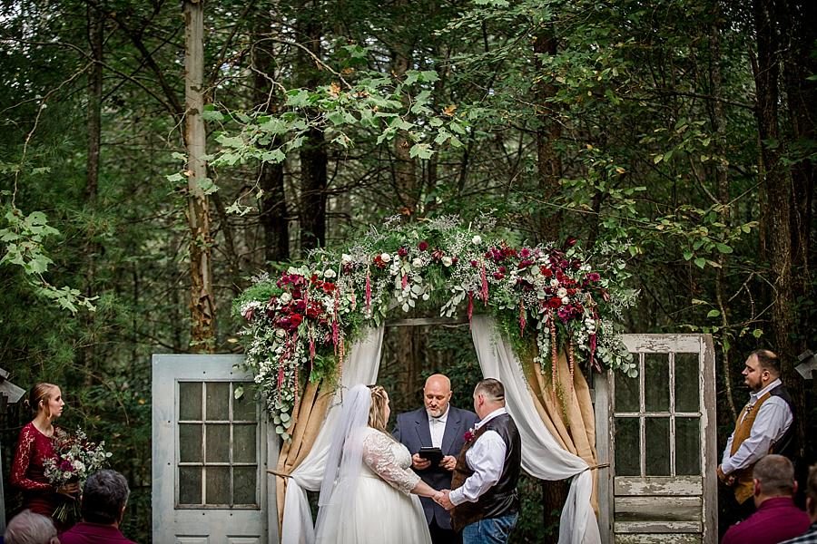 Under the arch at this Sampson's Hollow Fall Wedding by Knoxville Wedding Photographer, Amanda May Photos.