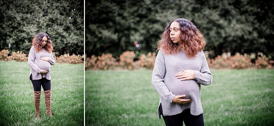 Holding her belly looking sideways at this Hope Resource Maternity session at UT Gardens by Knoxville Wedding Photographer, Amanda May Photos.