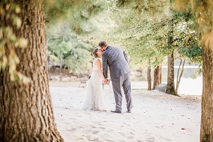 Kissing on the beach by Knoxville Wedding Photographer, Amanda May Photos.