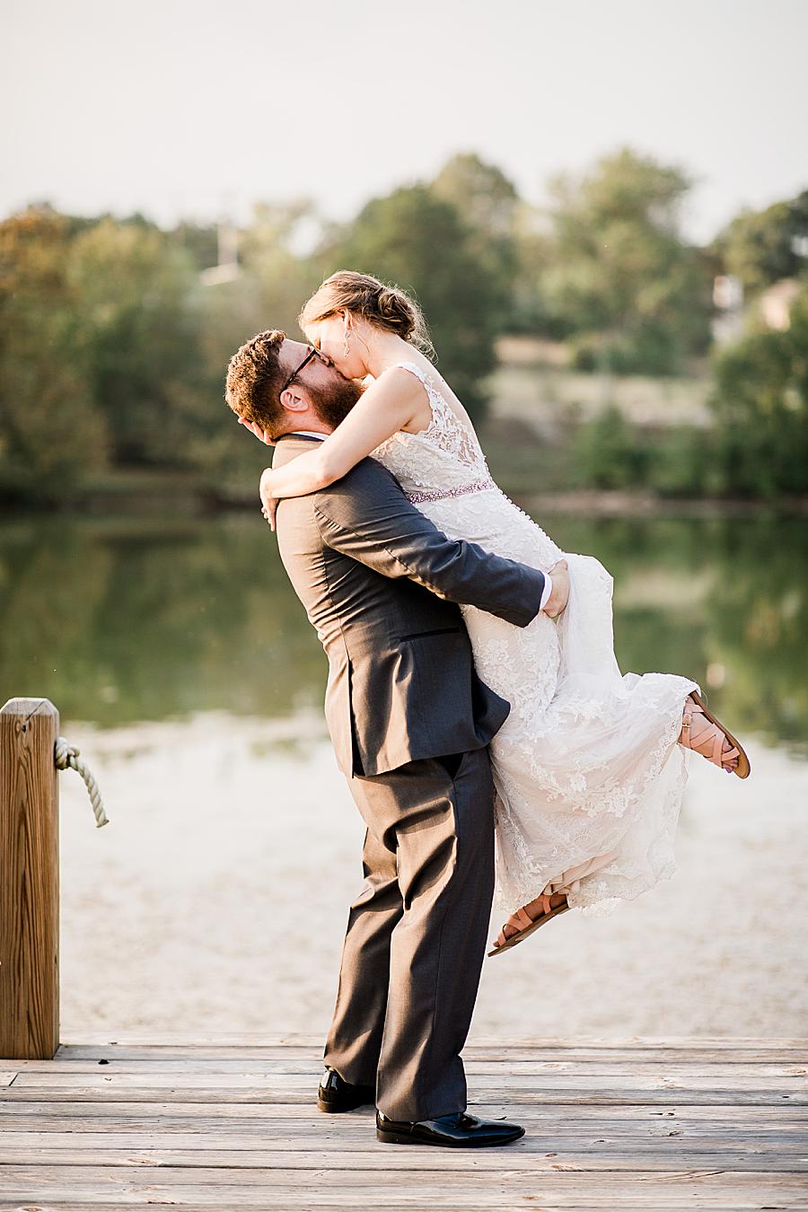 Groom holding bride by Knoxville Wedding Photographer, Amanda May Photos.