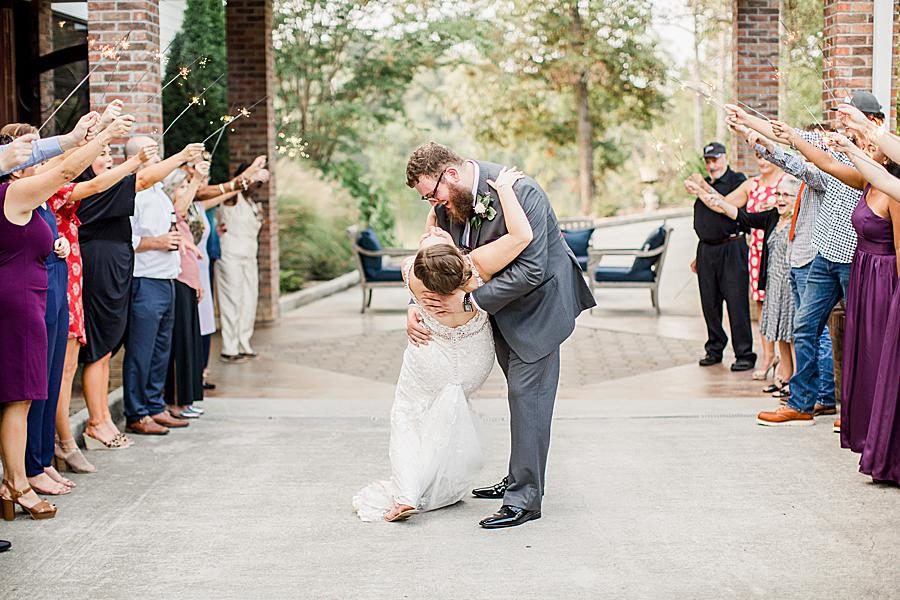 Groom dipping bride by Knoxville Wedding Photographer, Amanda May Photos.