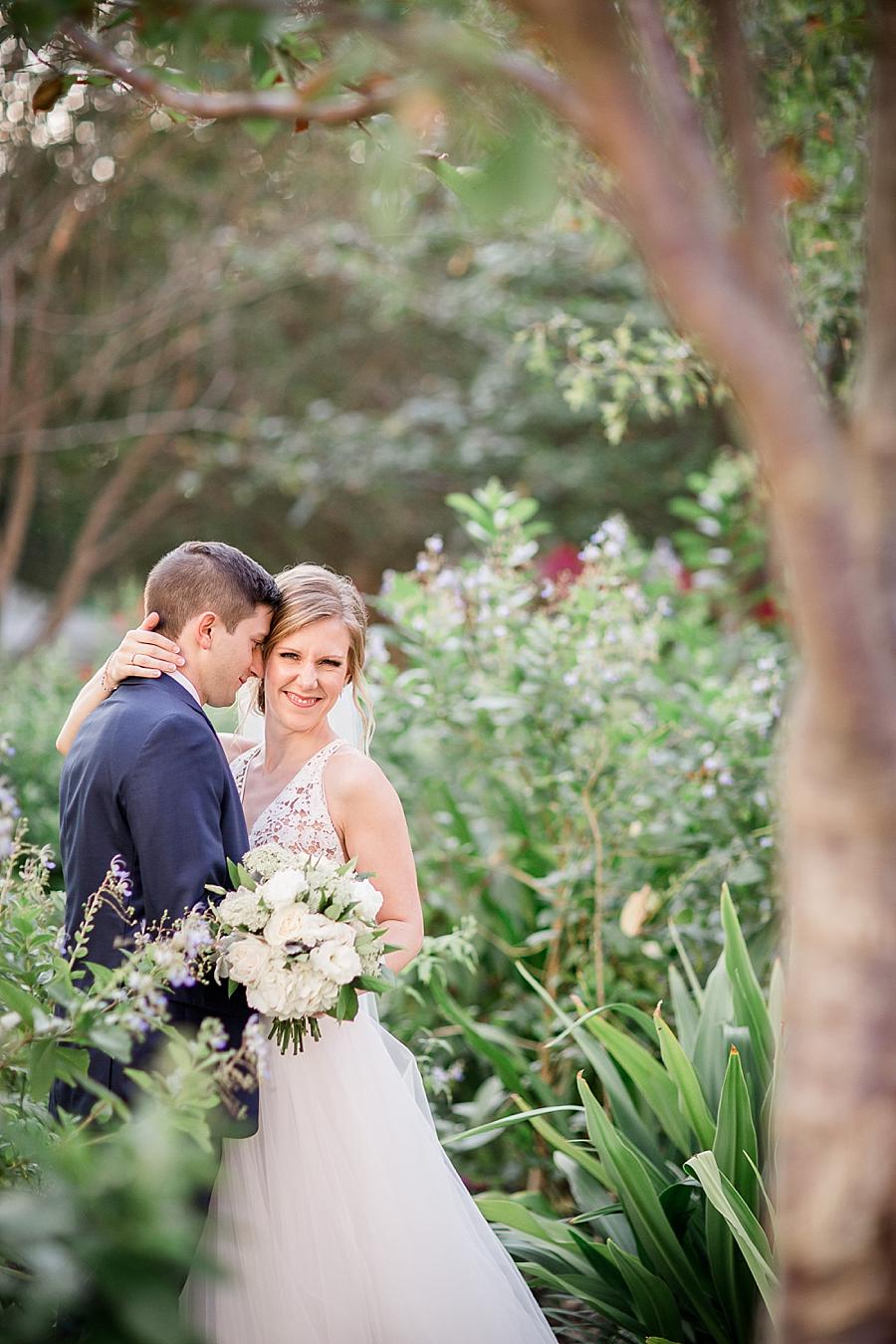In a garden at this Upstairs at Midtown Wedding by Knoxville Wedding Photographer, Amanda May Photos.