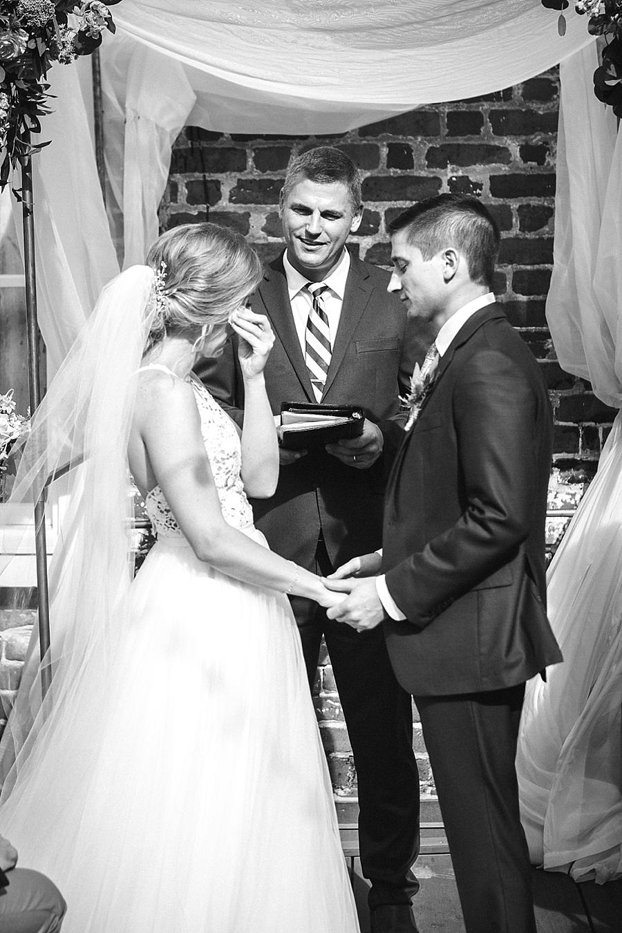 Wiping tears at this Upstairs at Midtown Wedding by Knoxville Wedding Photographer, Amanda May Photos.