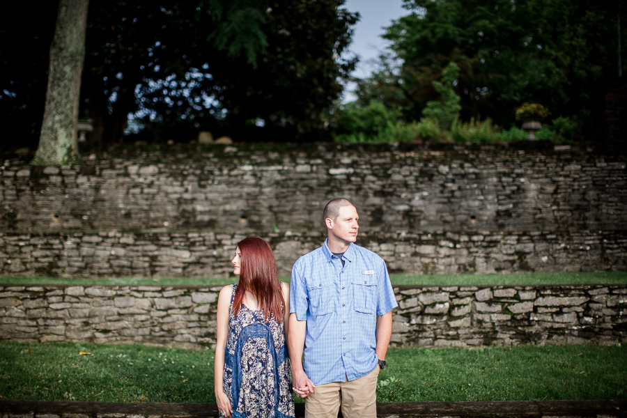 Holding hands looking away at this Knoxville Botanical Gardens engagement session by Knoxville Wedding Photographer, Amanda May Photos.