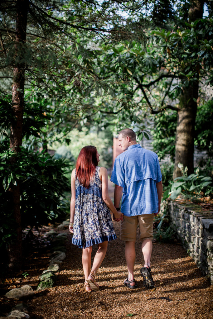 Walking away from the camera at this Knoxville Botanical Gardens engagement session by Knoxville Wedding Photographer, Amanda May Photos.