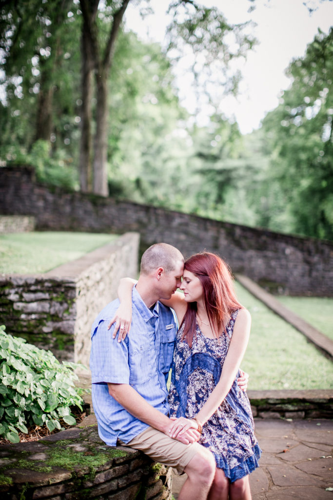 She sits on his lap at this Knoxville Botanical Gardens engagement session by Knoxville Wedding Photographer, Amanda May Photos.