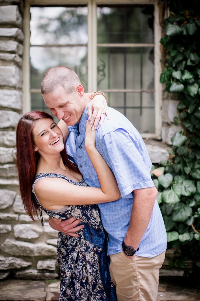 Arms hooked around his neck at this Knoxville Botanical Gardens engagement session by Knoxville Wedding Photographer, Amanda May Photos.
