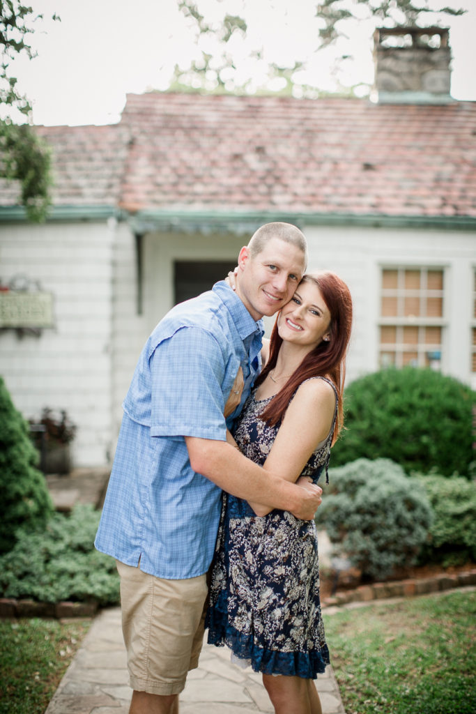 Cheeks together looking at the camera at this Knoxville Botanical Gardens engagement session by Knoxville Wedding Photographer, Amanda May Photos.