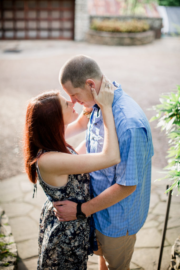 Her hands on his neck at this Knoxville Botanical Gardens engagement session by Knoxville Wedding Photographer, Amanda May Photos.