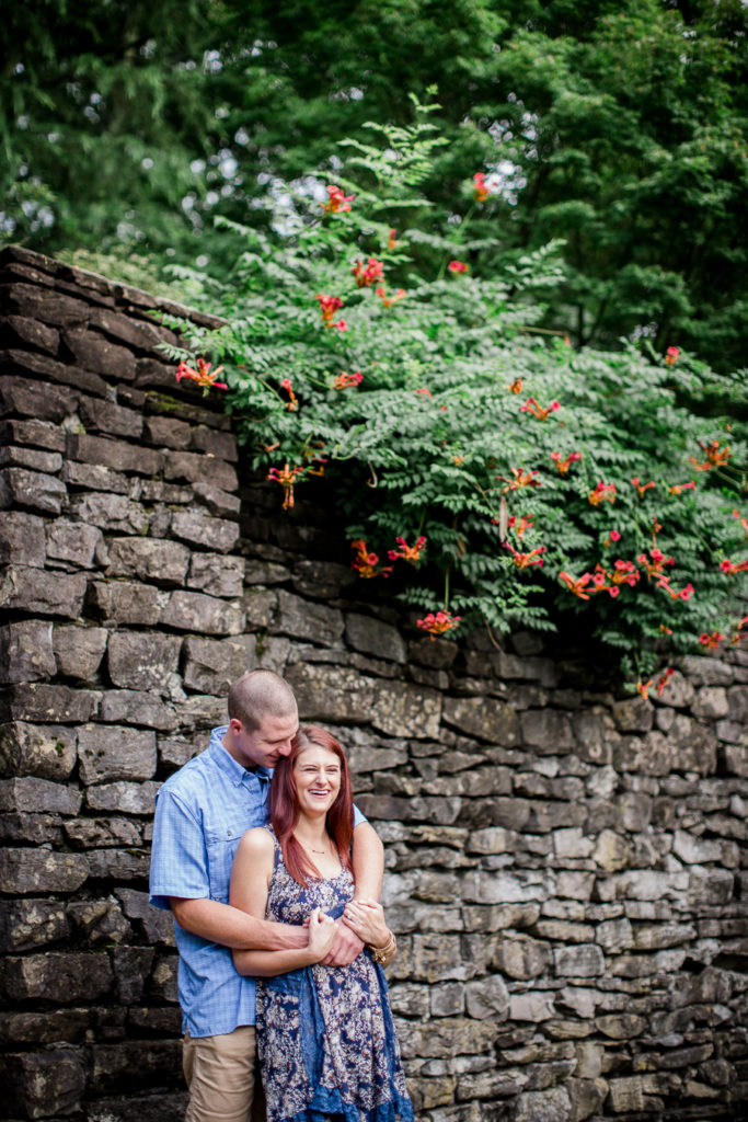 Standing under hanging vines at this Knoxville Botanical Gardens engagement session by Knoxville Wedding Photographer, Amanda May Photos.