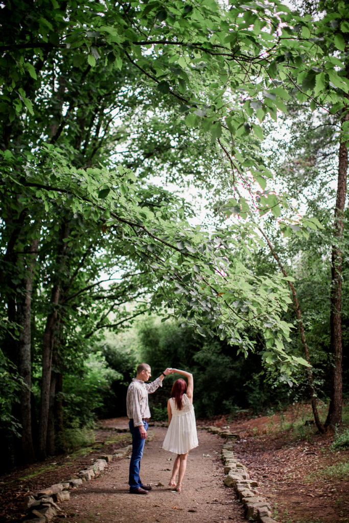 Twirling her under the trees at this Knoxville Botanical Gardens engagement session by Knoxville Wedding Photographer, Amanda May Photos.