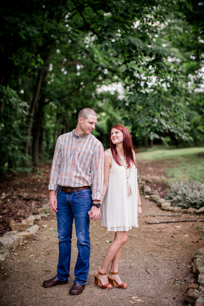 Back to back holding hands at this Knoxville Botanical Gardens engagement session by Knoxville Wedding Photographer, Amanda May Photos.
