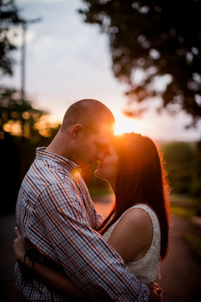 Foreheads together with the sunset at this Knoxville Botanical Gardens engagement session by Knoxville Wedding Photographer, Amanda May Photos.