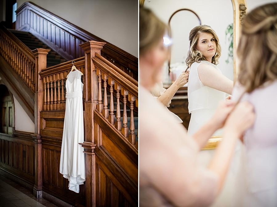 Buttoning the dress at this Southern Railway Station Wedding by Knoxville Wedding Photographer, Amanda May Photos.