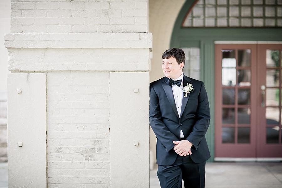 Leaning against a column at this Southern Railway Station Wedding by Knoxville Wedding Photographer, Amanda May Photos.