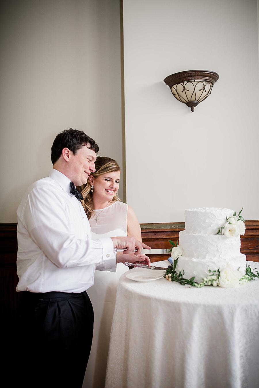 Cutting the cake at this Southern Railway Station Wedding by Knoxville Wedding Photographer, Amanda May Photos.