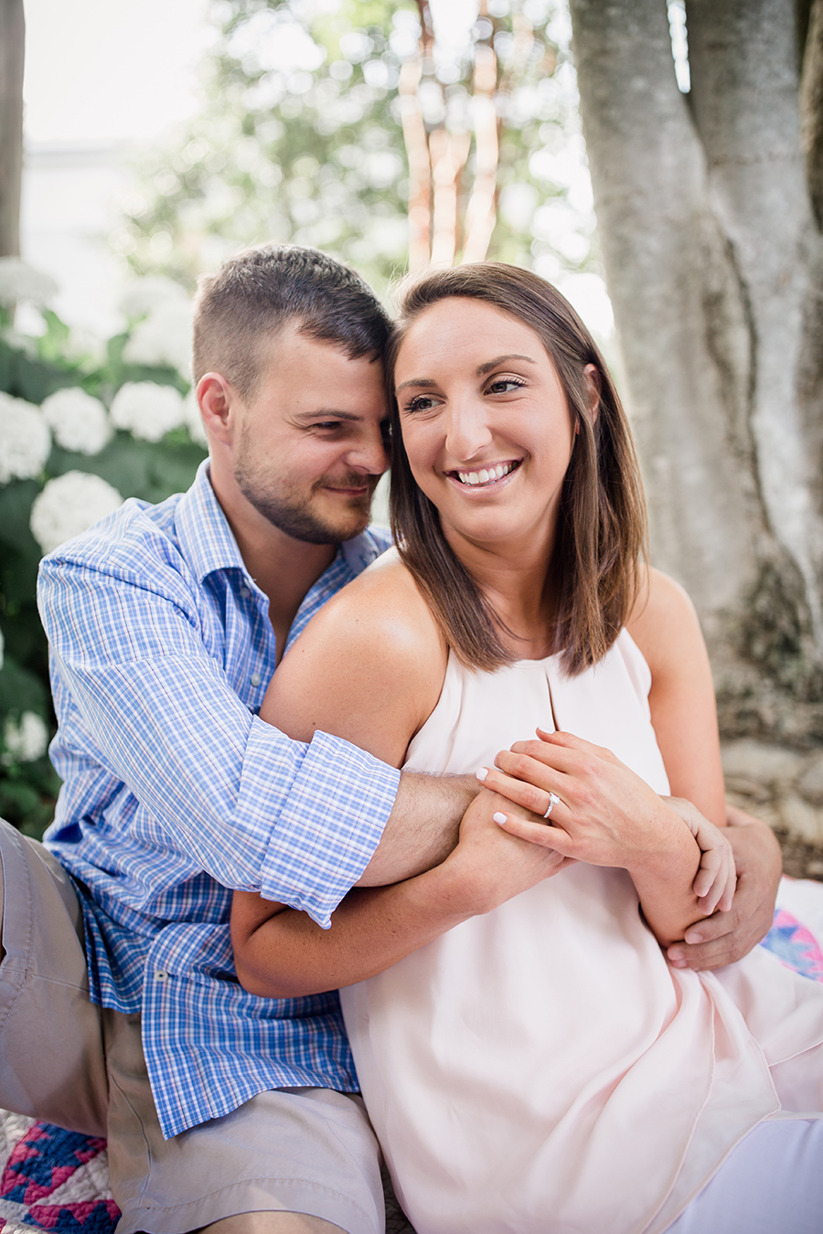 Sitting down hugging her at this Estate of Grace engagement session by Knoxville Wedding Photographer, Amanda May Photos.