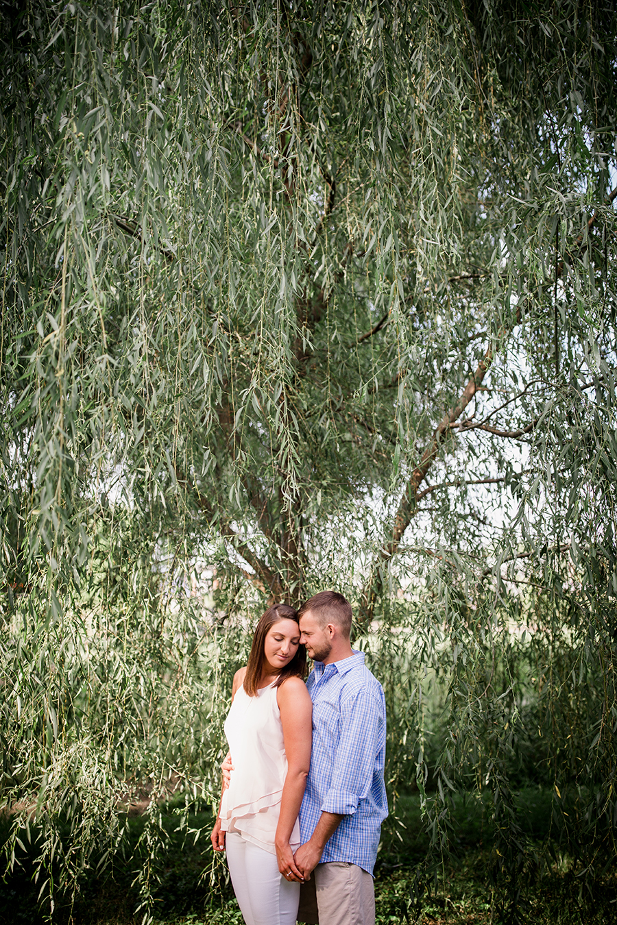 Holding from behind in front of tree at this Estate of Grace engagement session by Knoxville Wedding Photographer, Amanda May Photos.