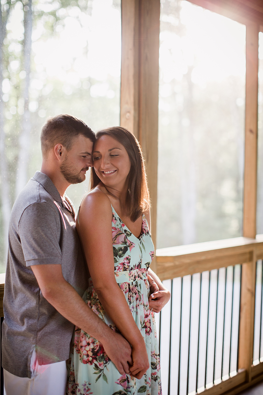 Holding from behind on porch at this Estate of Grace engagement session by Knoxville Wedding Photographer, Amanda May Photos.