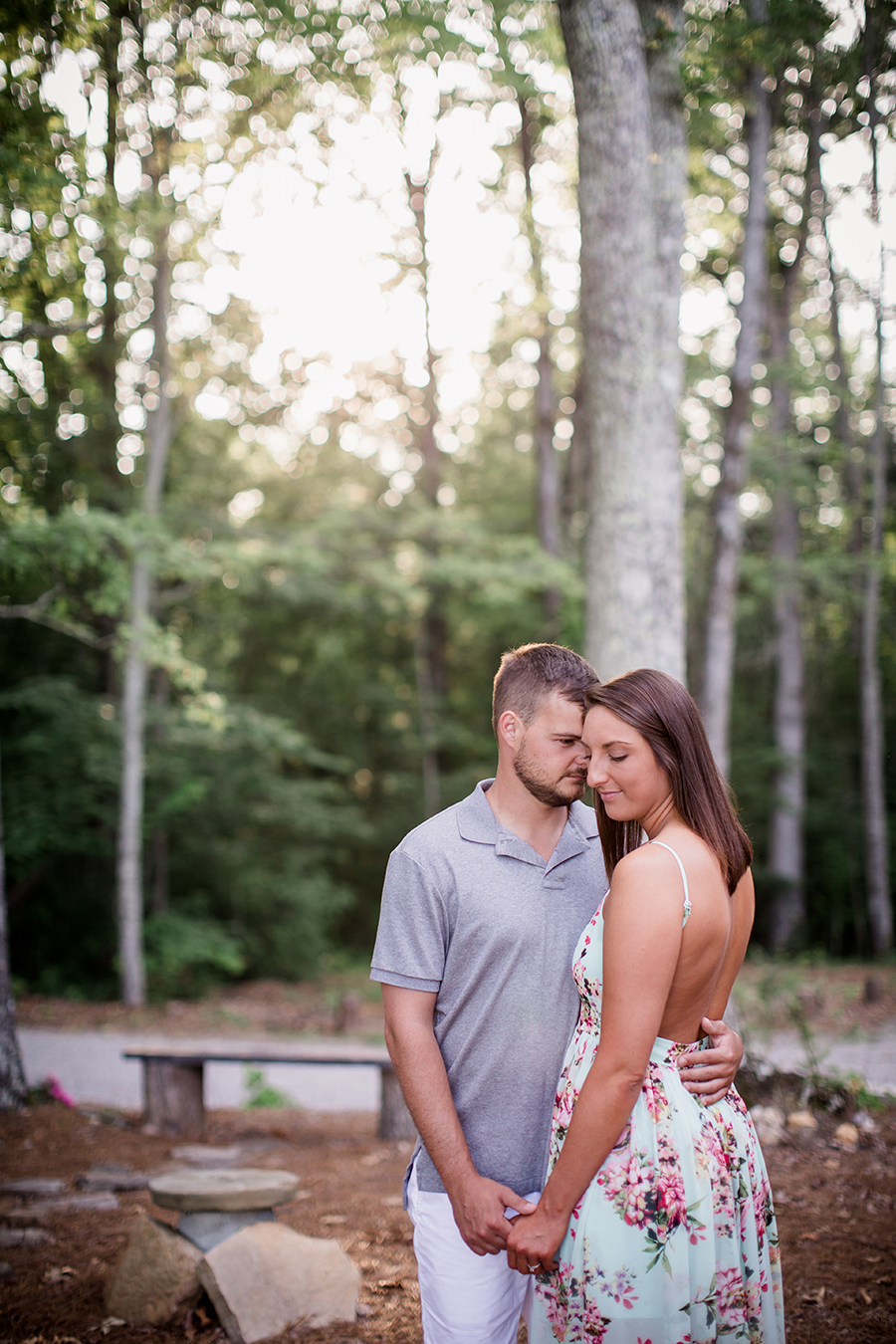 Looking at each other with woods in background at this Estate of Grace engagement session by Knoxville Wedding Photographer, Amanda May Photos.