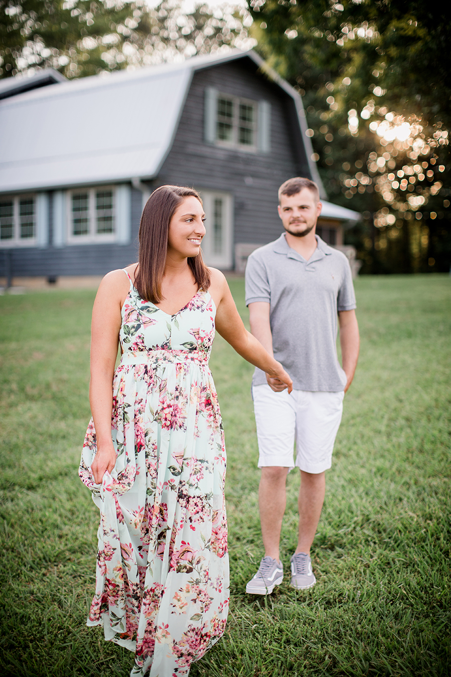 Holding hands in front of barn at this Estate of Grace engagement session by Knoxville Wedding Photographer, Amanda May Photos.