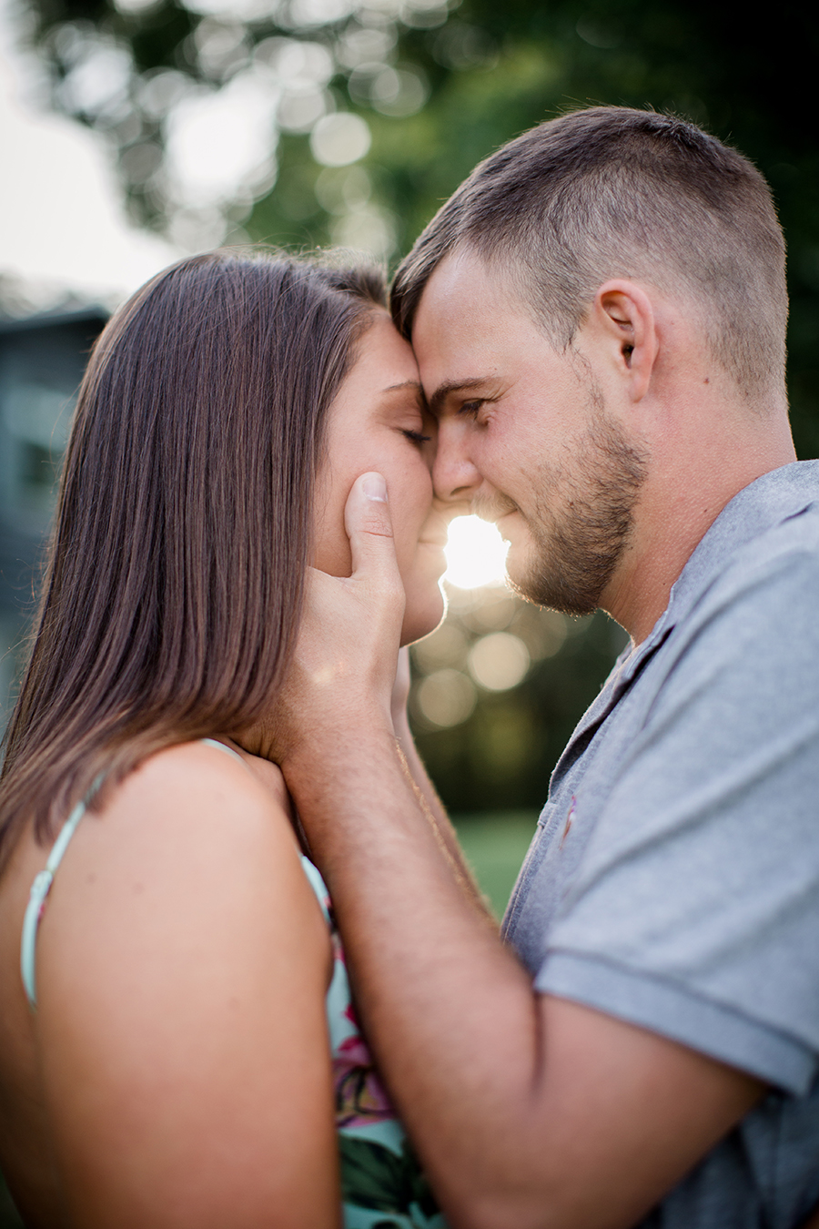 Kissing with sun behind faces at this Estate of Grace engagement session by Knoxville Wedding Photographer, Amanda May Photos.